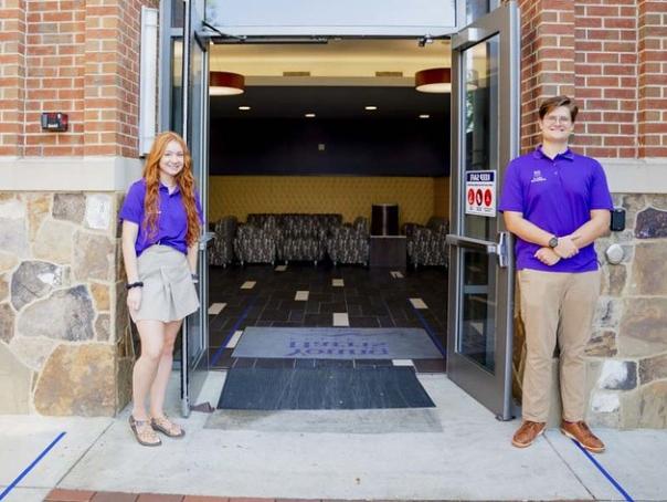 a couple of women standing in a doorway of a building