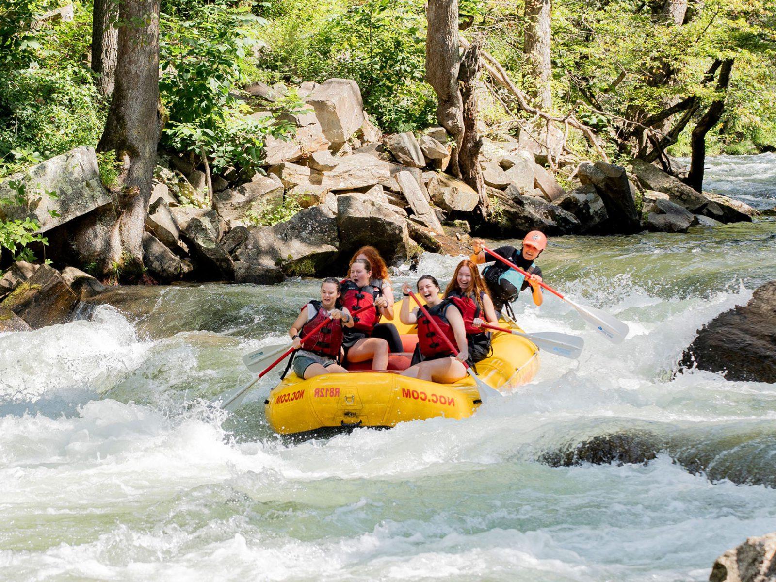 a group of people in a raft on a river